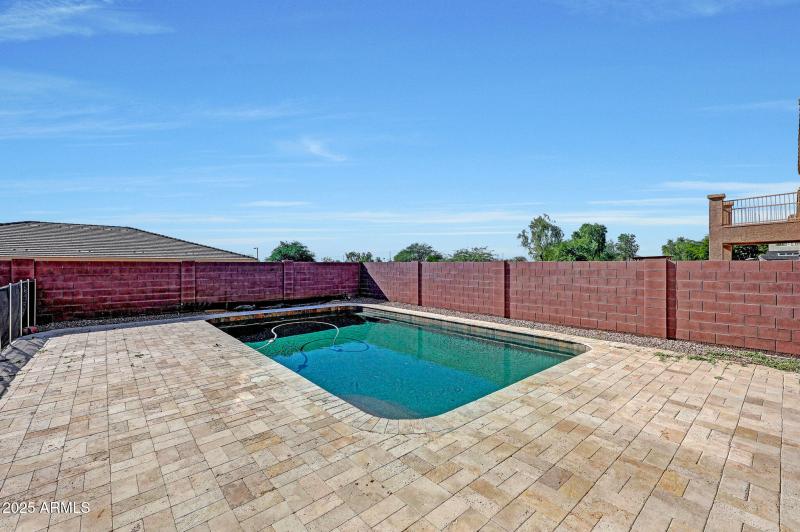 Pebbletec pool with travertine decking