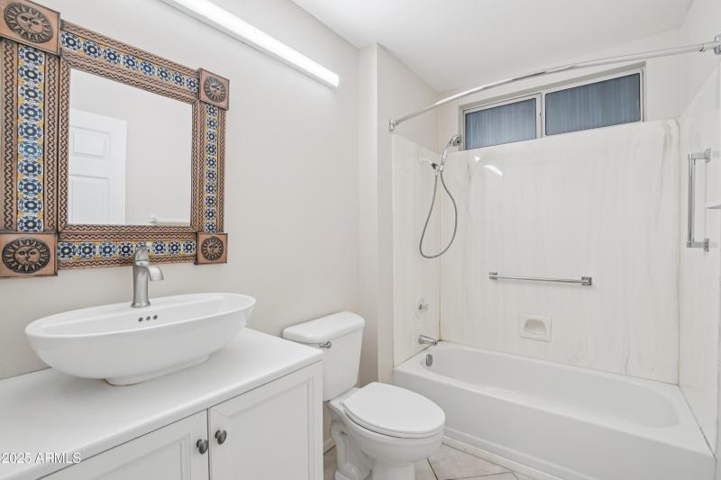 Guest bathroom with tub and shower