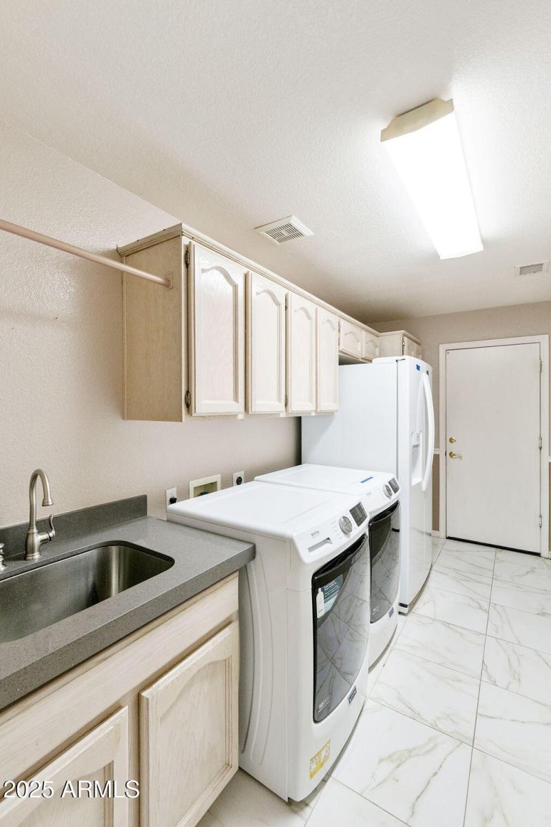Laundry with sink and cabinets
