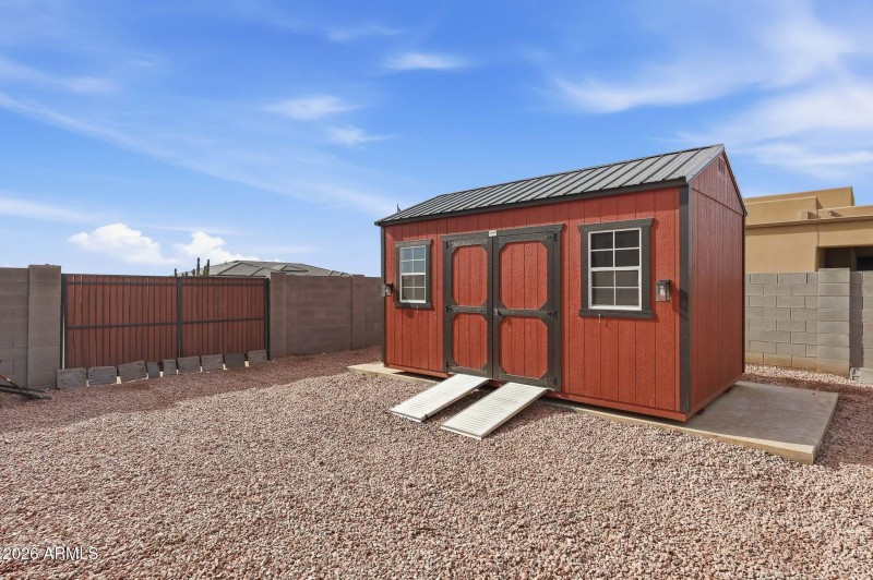 Storage shed for feed and riding mower