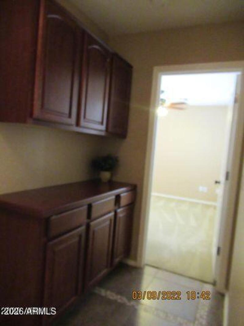 halway with storage leads to downstairs