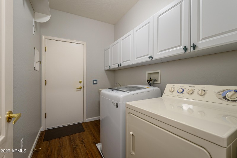 Fabulous Laundry area with cabinets