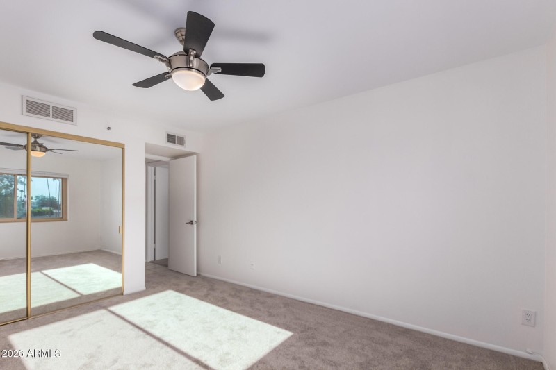MIRRORED CLOSET DOORS IN BEDROOM