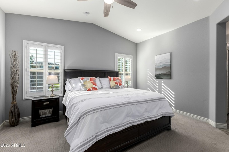 Primary bedroom w/ vaulted ceilings