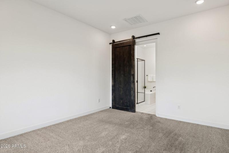 Primary bedroom with barn door