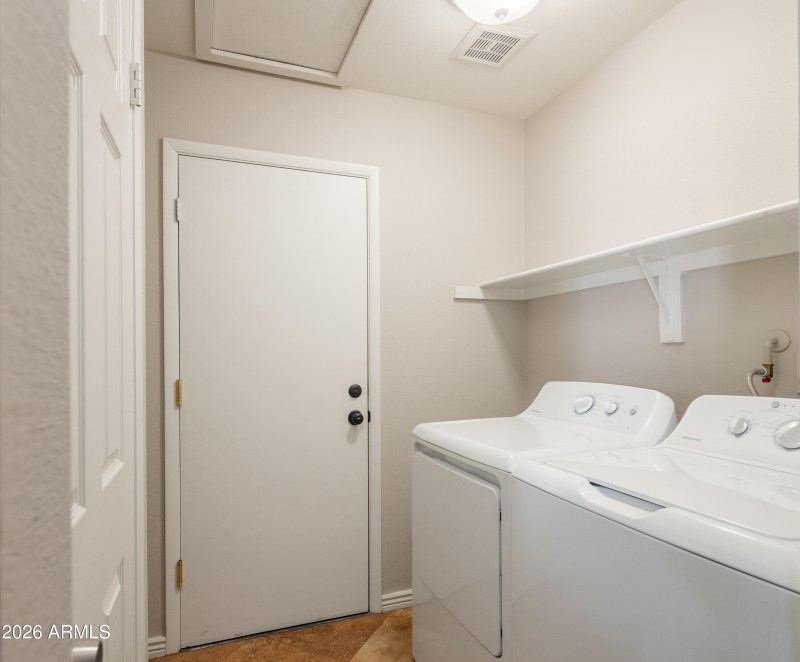 Laundry room adjacent to the garage