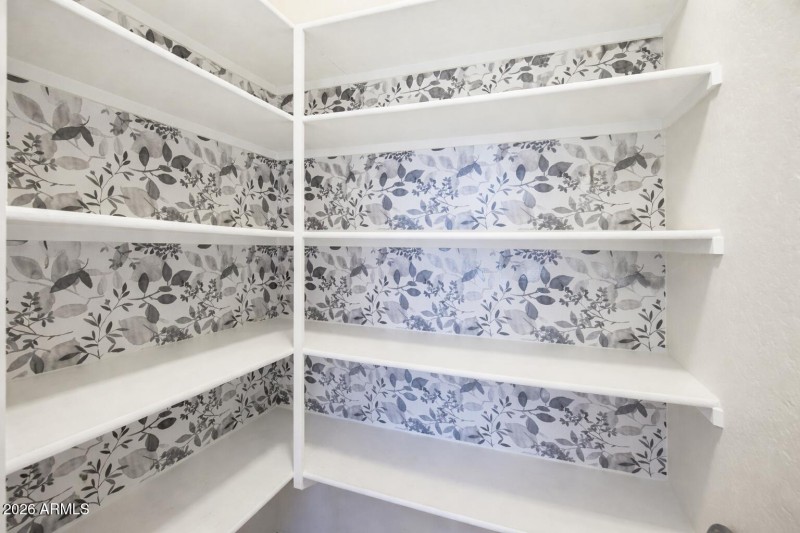 Empty pantry with floral wallpaper