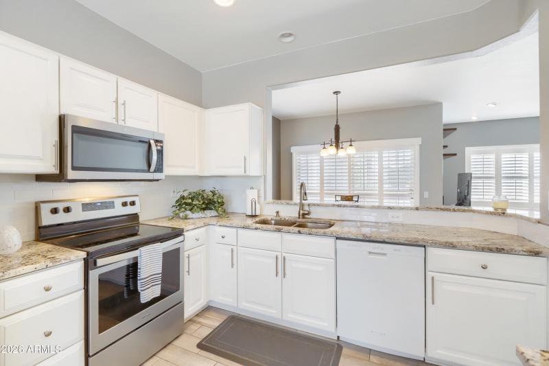 Kitchen view of Dining Room & Backyard