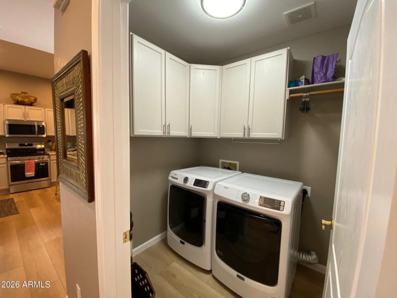 Roomy laundry with storage and hanging s