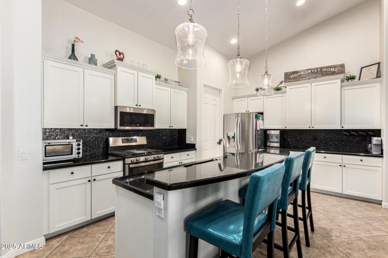 white kitchen with huge vaulted ceilings