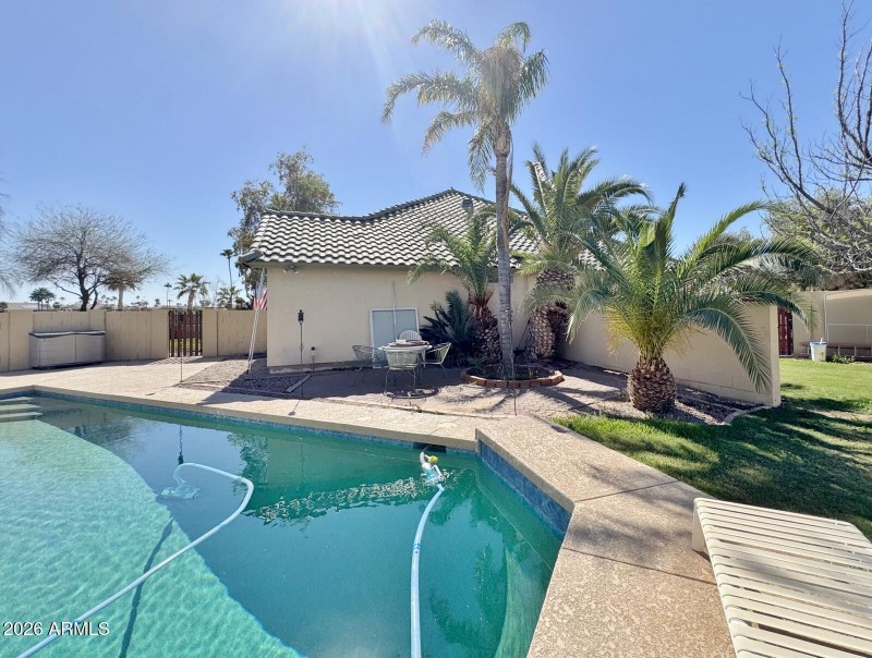 Pool, patio and grassy area