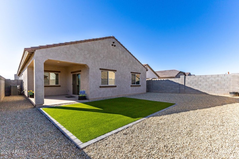 BACK OF HOME WITH FLOWER POTS