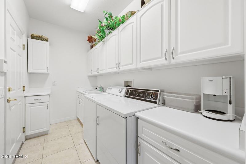 Inside laundry w/ cabinets & sink