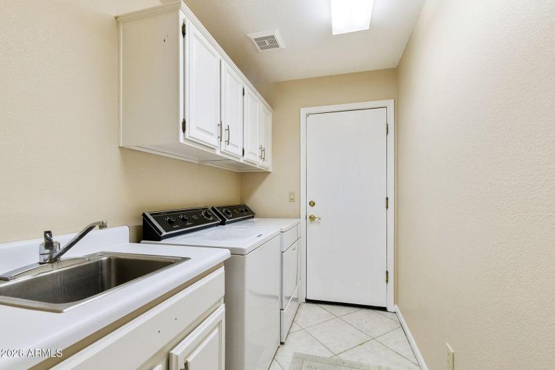 Laundry with sink and cabinets