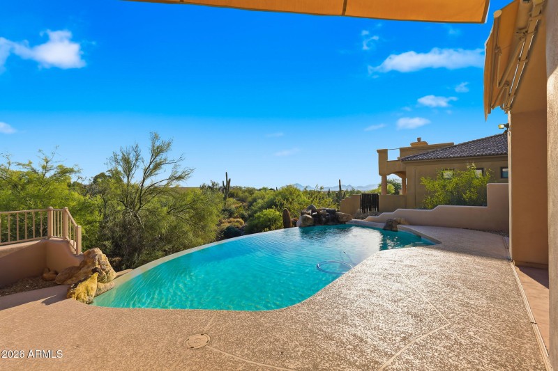 Pool with city and mountain views