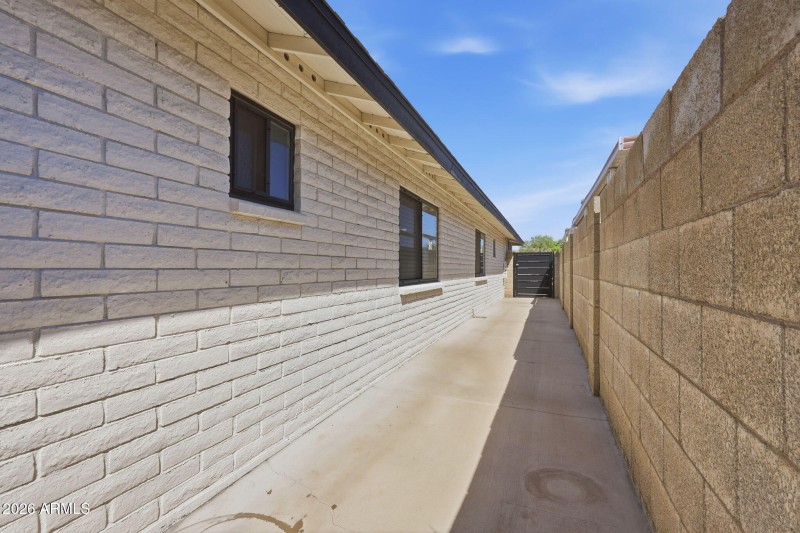 Paved side yard with gate access