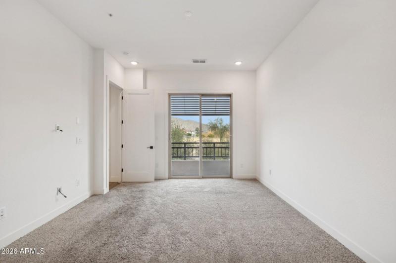 Primary bedroom with slider to balcony