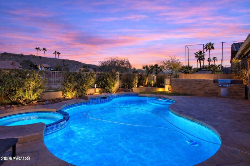 Twilight oasis with pool and palms