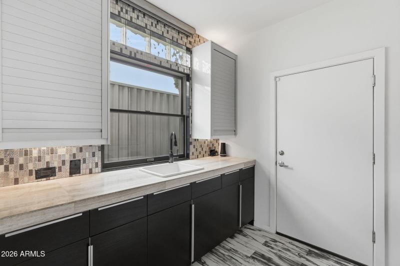 Laundry w/ Mosaic Tile Backsplash