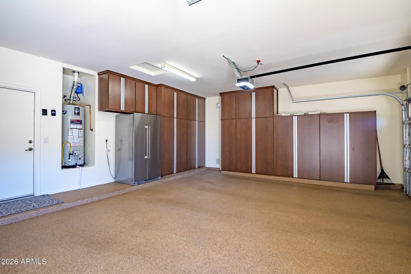 Garage with cabinets and an epoxy floor