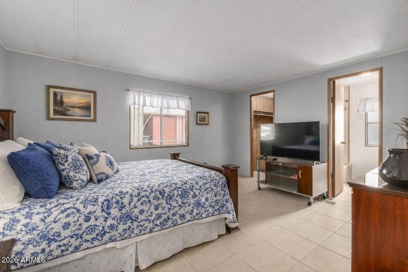 Serene bedroom with landscape artwork (1