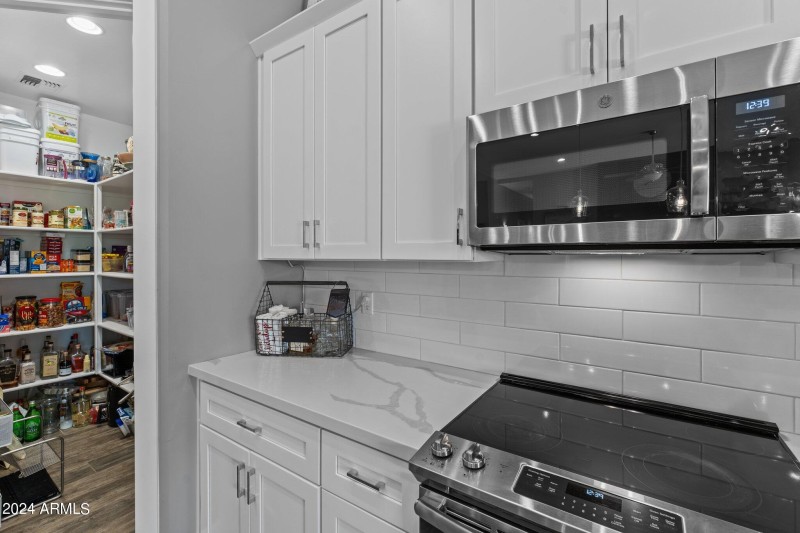 Pantry adjacent to cooking area