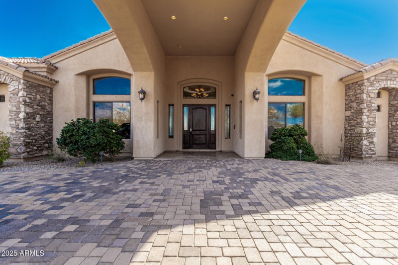 Tall covered motor coach entrance.