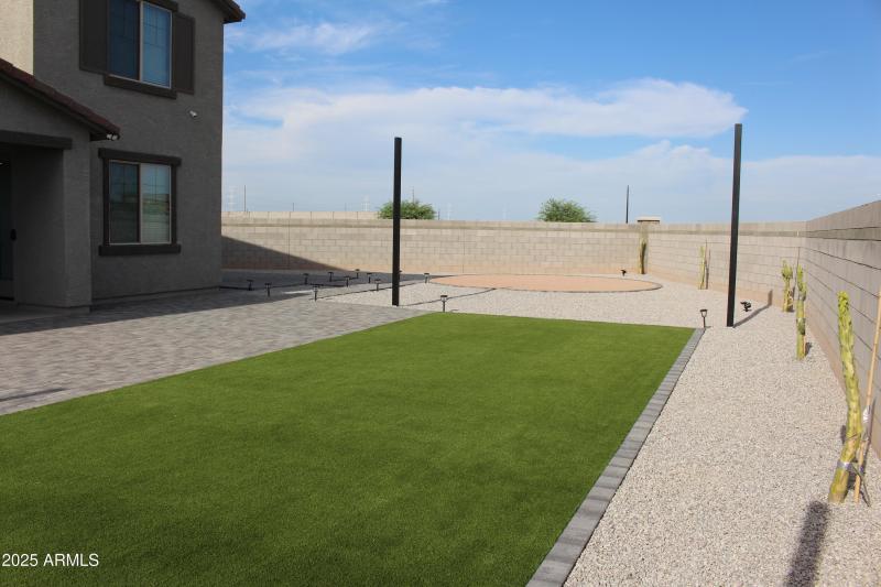 Backyard by design with turf and pavers