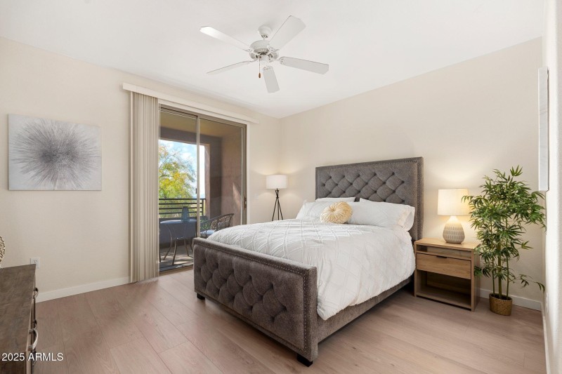 Primary bedroom with balcony and views