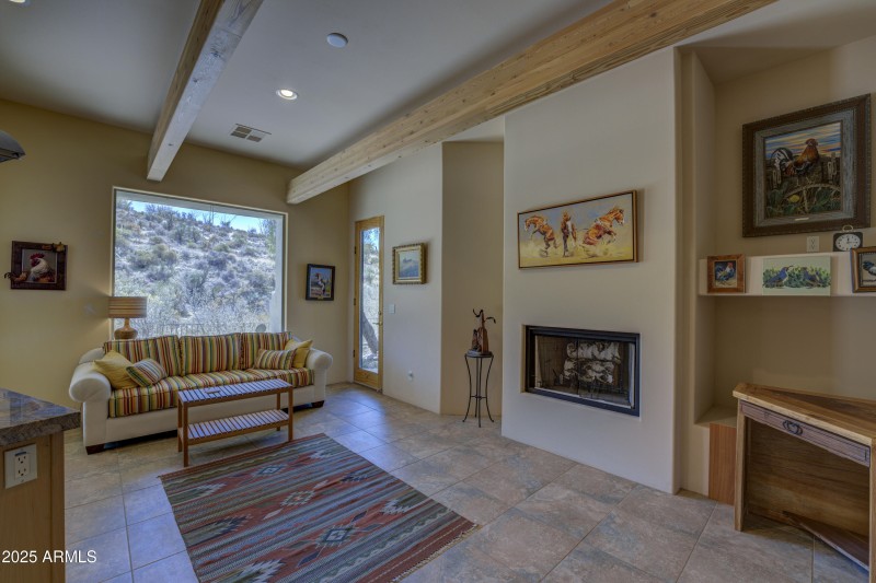 Sitting area with fireplace off kitchen