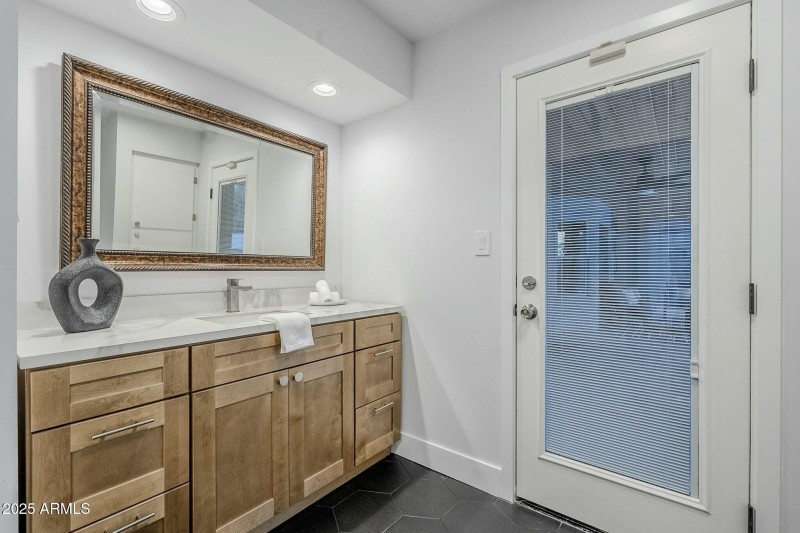 Primary Vanity Two & Exit to Patio