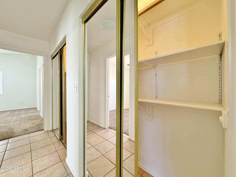 Lighted storage & closet space in hall