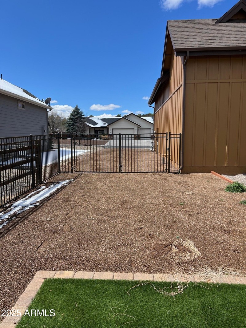 Double wrought iron gate on side yard
