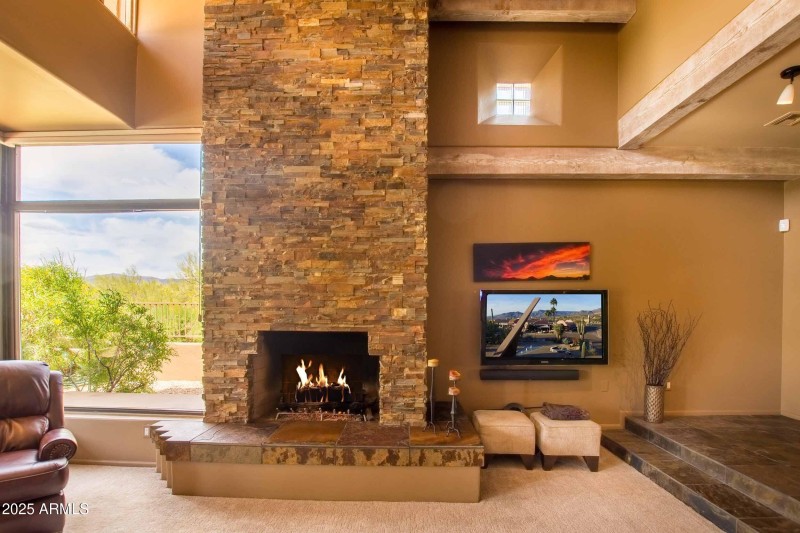 grand fireplace with door closed with tv
