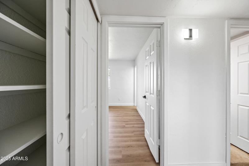 Linen Closet and Door to Primary Suite