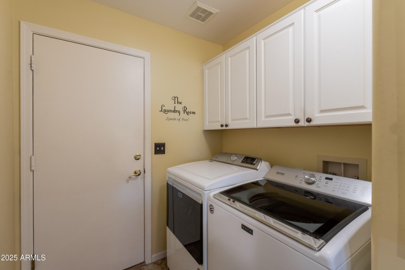 Laundry room with cabinets.