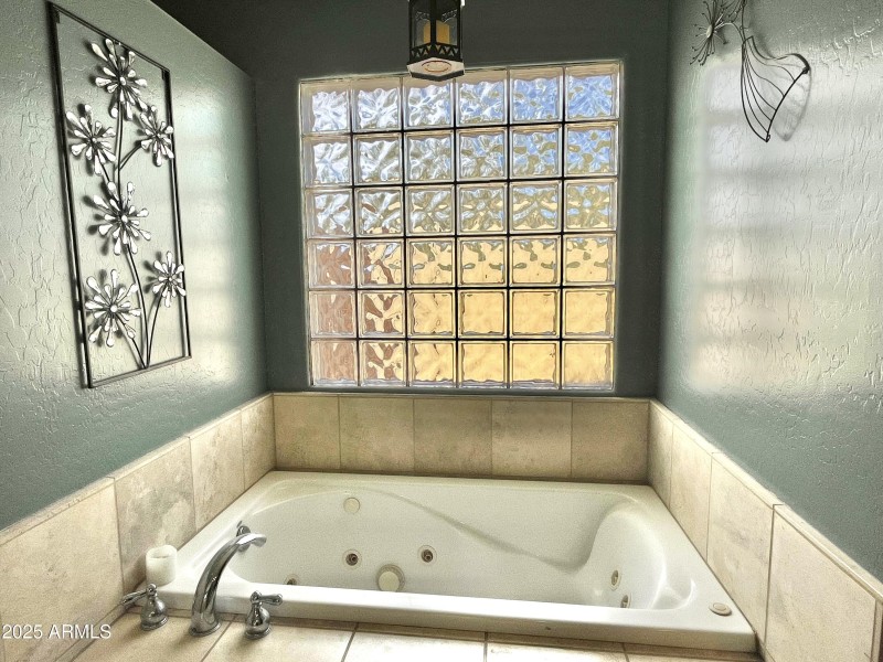 Tiled jetted tub in Primary