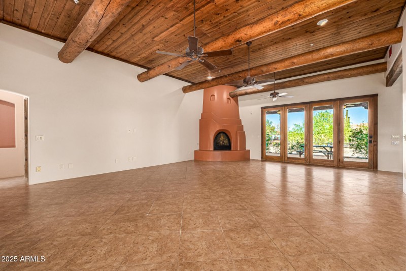GREATOOM WITH WALL OF WINDOWS TO BACKYAR