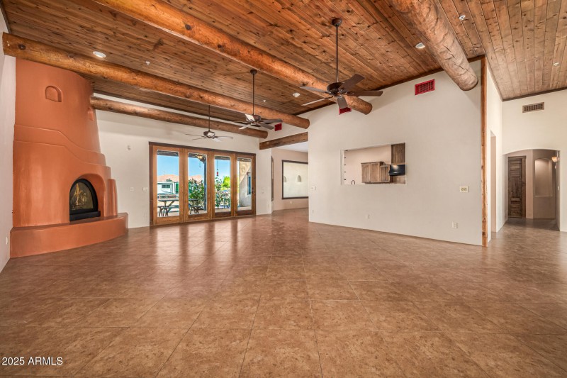 GREATOOM WITH WALL OF WINDOWS TO BACKYAR