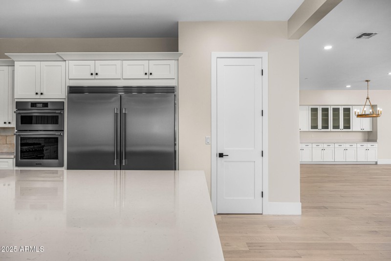 kitchen w/ side by side SS fridge