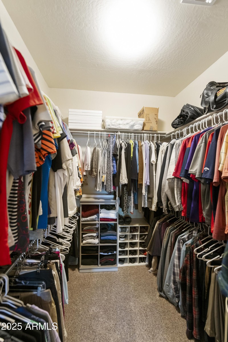 Primary bedroom walk-in closet