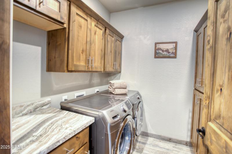 Laundry near kitchen has extra storage