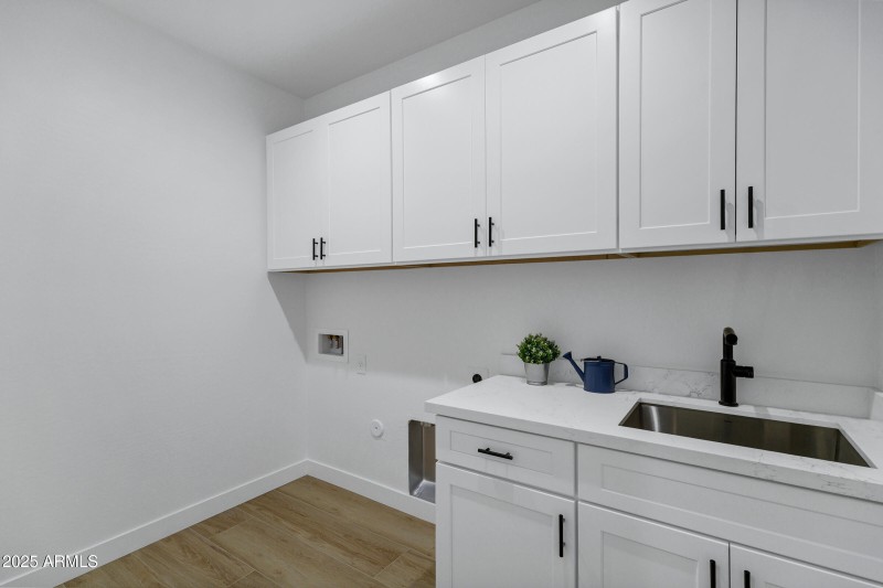 Laundry Room with Cabinets and Sink