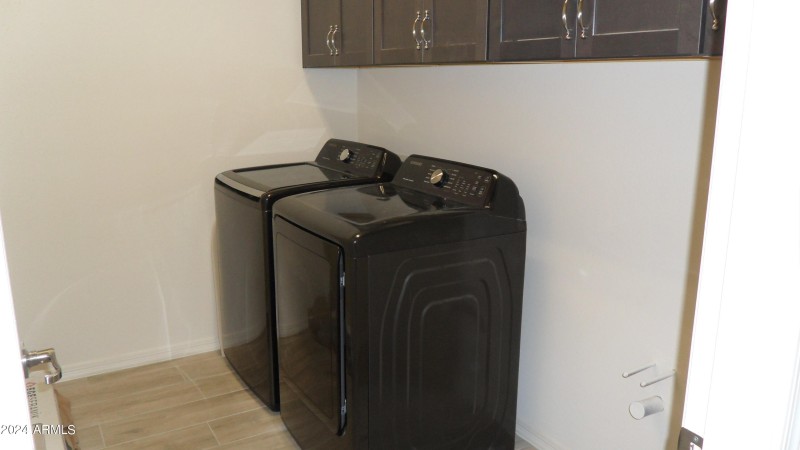 INSIDE LAUNDRY ROOM W/ WASHER AND DRYER