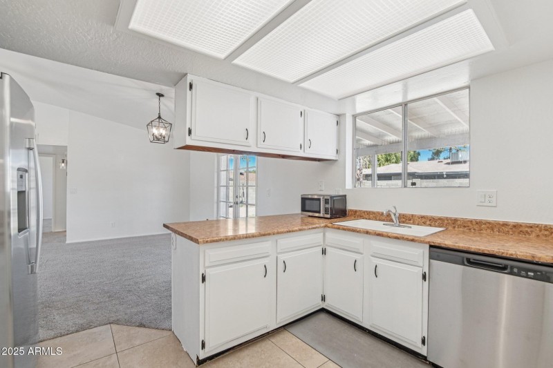 Kitchen sink looking to backyard