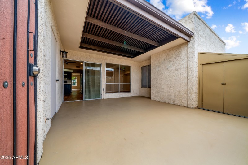 Covered Back Patio Has Storage Shed