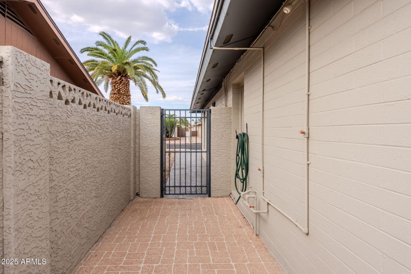 Side gate with sidewalk to front
