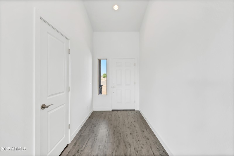 Foyer entry to home with tile.