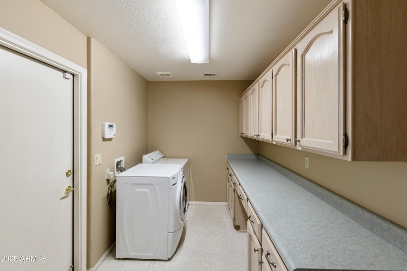 Laundry with cabinets/counter
