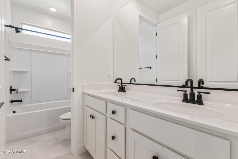 Full Bathroom with Dual Sinks and 2 Do